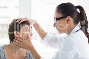 Doctor checking woman eye