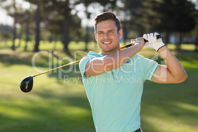 Portrait of handsome man with golf club