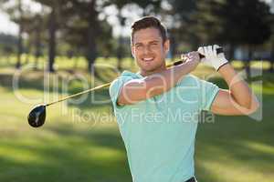 Portrait of handsome man with golf club