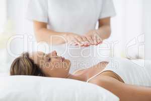 Young woman receiving reiki treatment