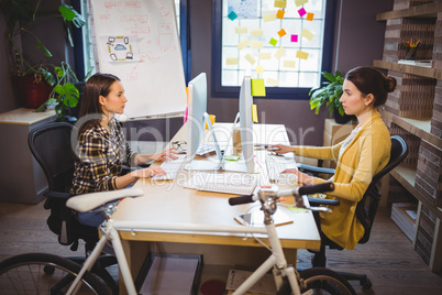 Female colleagues working on computer
