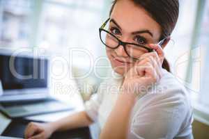 Graphic designer adjusting eyeglasses