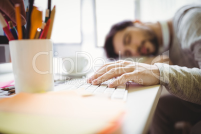 Businessman taking nap in office