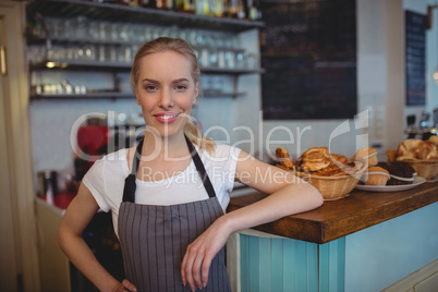 Portrait of confident female barista at cafe