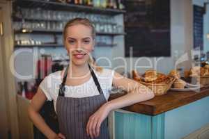 Portrait of confident female barista at cafe