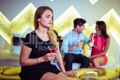 Woman sitting by happy couple