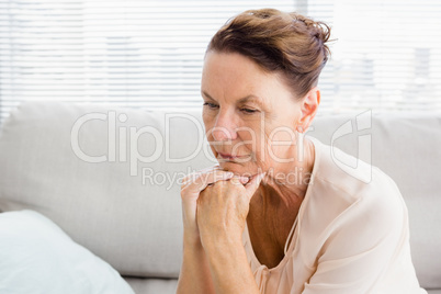 Close-up of thoughtful woman with hands on chin