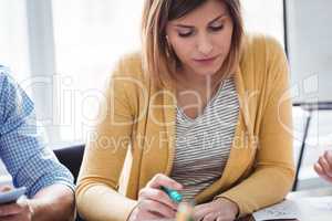 Female photo editor with colleagues in meeting room