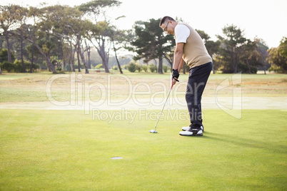 Profile view of sportsman playing golf