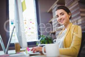 Young creative businesswoman working at computer desk