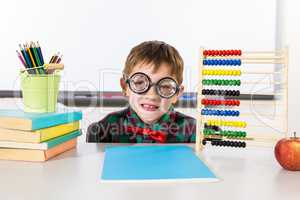 Boy with books and abacus in classroom