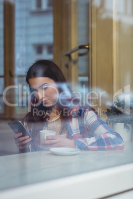 Beautiful woman using smartphone at cafe