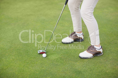 Low section of woman playing golf