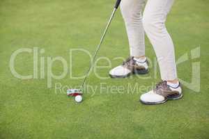 Low section of woman playing golf