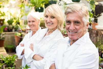 Confident male and female scientists at greenhouse