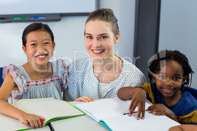 Happy teacher with schoolchildren