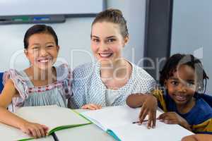 Happy teacher with schoolchildren