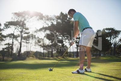 Full length of young man playing golf