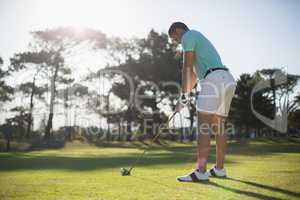 Full length of young man playing golf