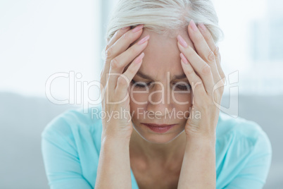 Close-up of senior woman suffering headache