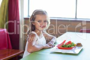 Portrait of smiling girl having meal