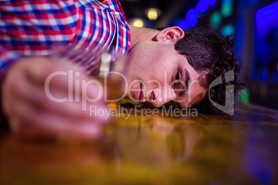 Portrait of drunk man at bar counter