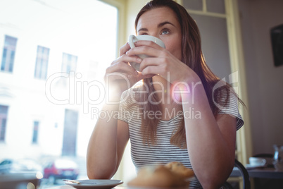 Beautiful woman sipping coffee at cafe