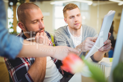 Businessman discussing documents with colleagues in office