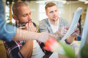Businessman discussing documents with colleagues in office