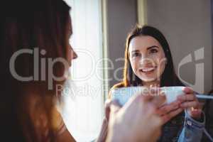 Happy woman with friend at cafeteria