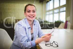 Cheerful businesswoman holding document