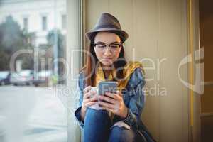 Beautiful woman using cellphone at cafe