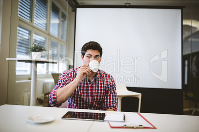 Businessman having coffee in meeting room