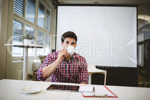 Businessman having coffee in meeting room