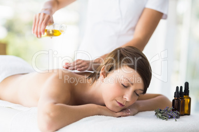 Relaxed woman receiving massage treatment