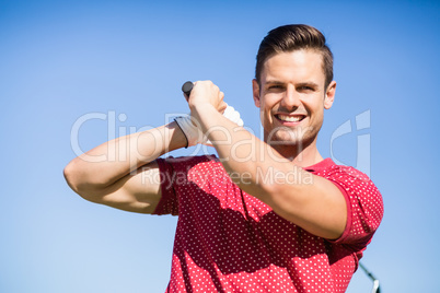 Portrait of golfer man taking shot