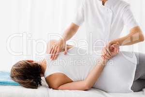 Masseur giving massage to woman