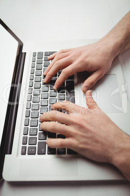 Cropped image of man working on laptop