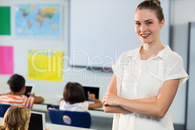 Female teacher standing with arms crosse