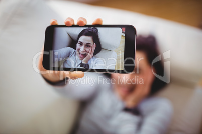 High angle view of happy woman taking selfie