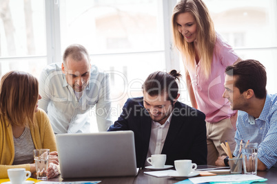 Business people with laptop in meeting room