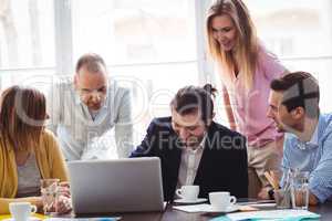 Business people with laptop in meeting room