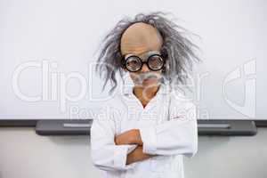Boy dressed as scientist standing in classroom