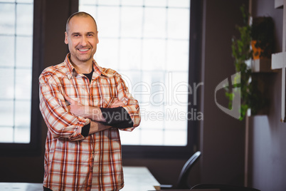 Confident businessman standing with arms crossed