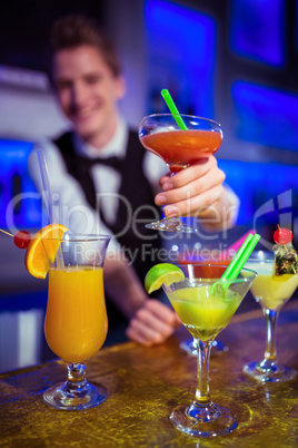 Bartender holding cocktail glass