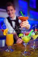 Bartender holding cocktail glass