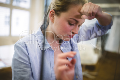 Depressed businesswoman seen through glass