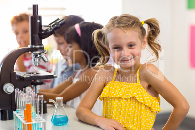 Girl with classmates in laboratory