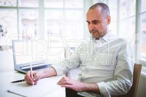 Businessman writing document