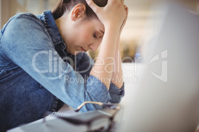 Stressed businesswoman in creative office